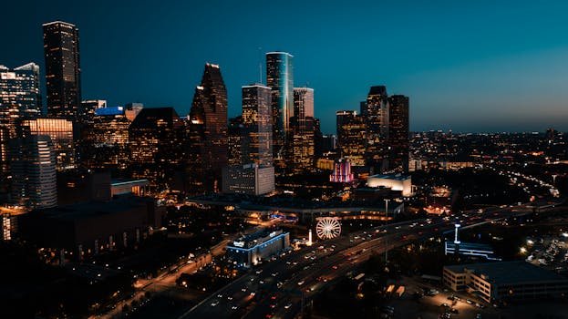 Stunning aerial view of downtown Houston's illuminated skyscrapers at dusk.